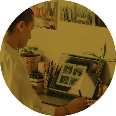 A person uses a drawing tablet while working on their computer