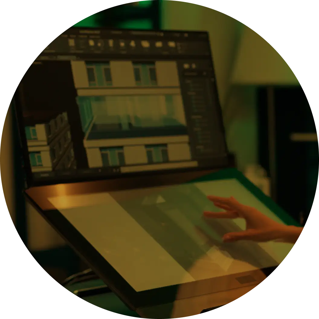 A person uses a drawing tablet while working on their computer